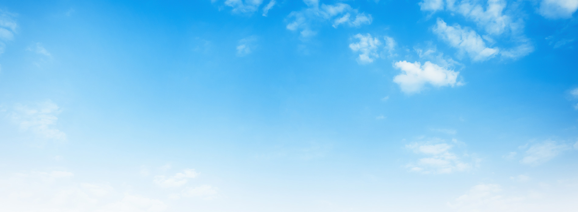 The image shows a clear blue sky with scattered clouds, and below it is a view of a landscape that includes a body of water and what appears to be a horizon line.